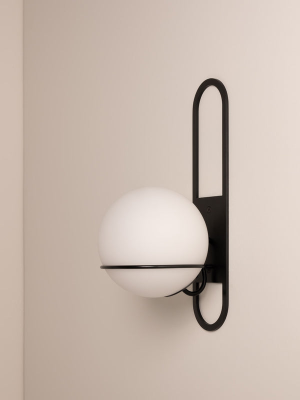 Cradle wall sconce shown in blackened steel finish, side angle