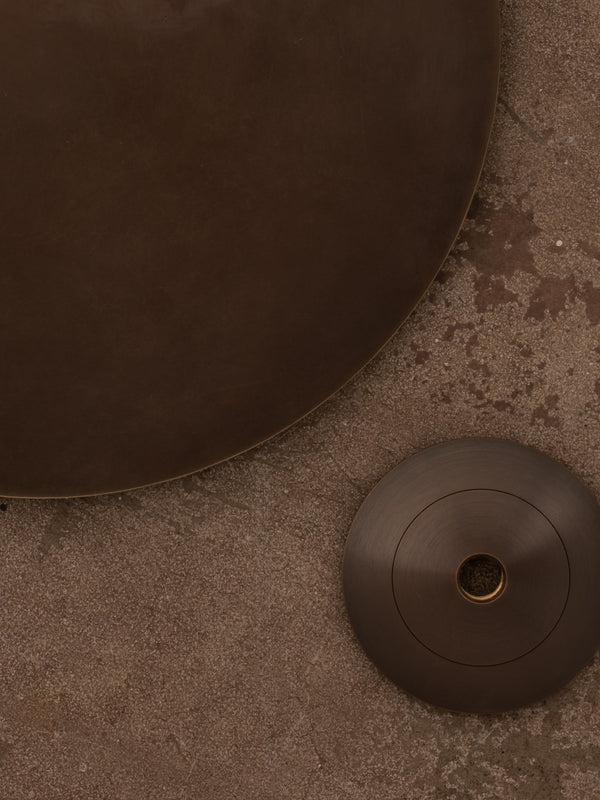 Examples of dark bronze finish shown against a distressed concrete floor