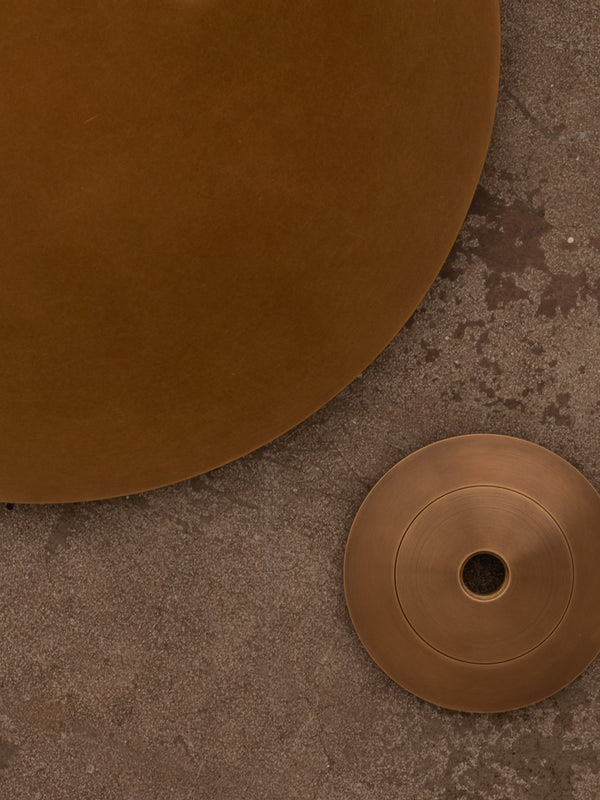 Examples of antique brass finish shown against a distressed concrete floor