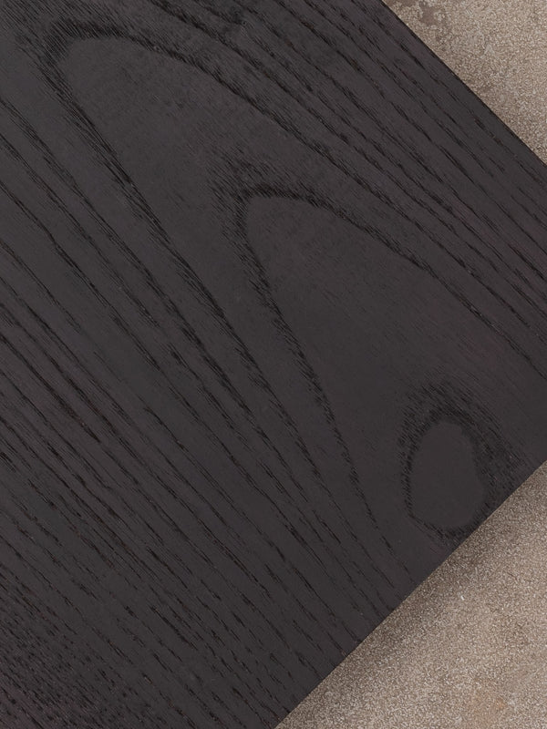 Example of blackened ash finish shown against a distressed concrete floor