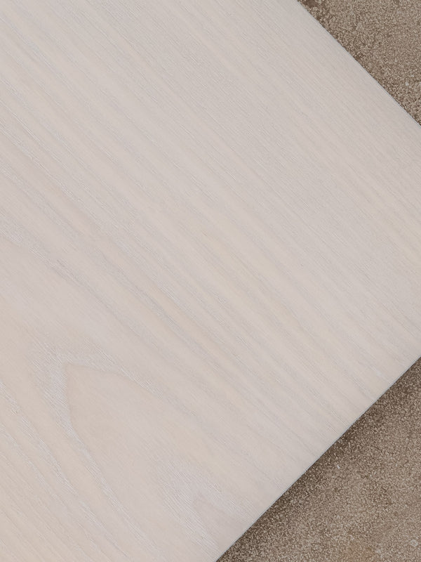 Example of bleached ash finish shown against a distressed concrete floor