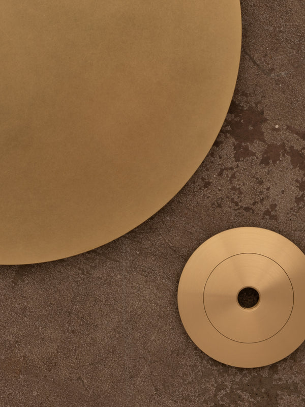 Examples of natural brass finish shown against a distressed concrete floor