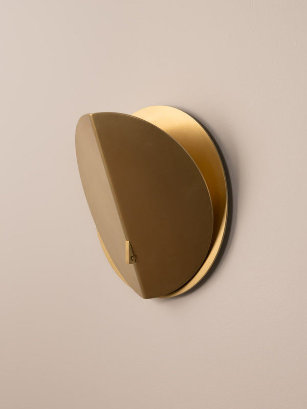 Folded wall sconce shown in natural brass finish, side angle