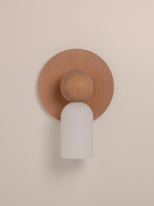Libby wall sconce shown in natural oak finish, front view