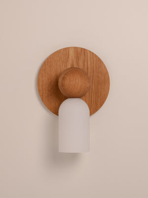 Libby wall sconce shown in warm oak finish, front view