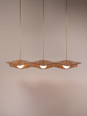 Wave III chandelier shown in natural oak and natural brass finishes, front view, illuminated